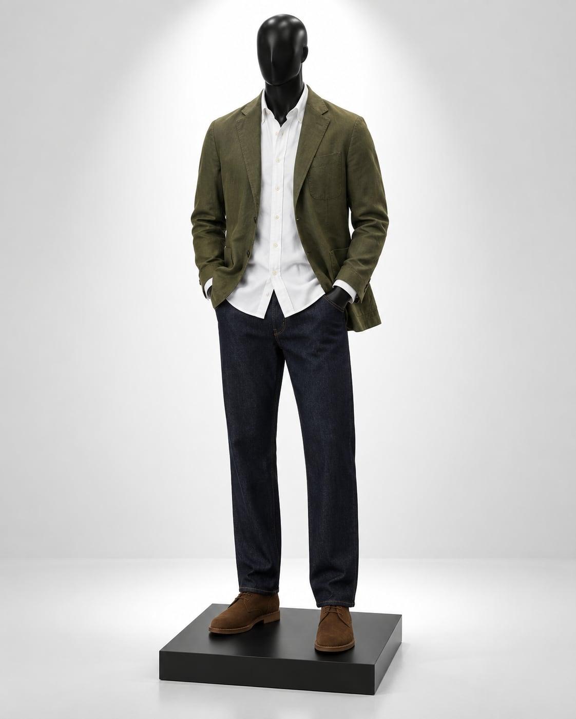 Black mannequin in an olive unstructured blazer, white Oxford shirt and dark jeans